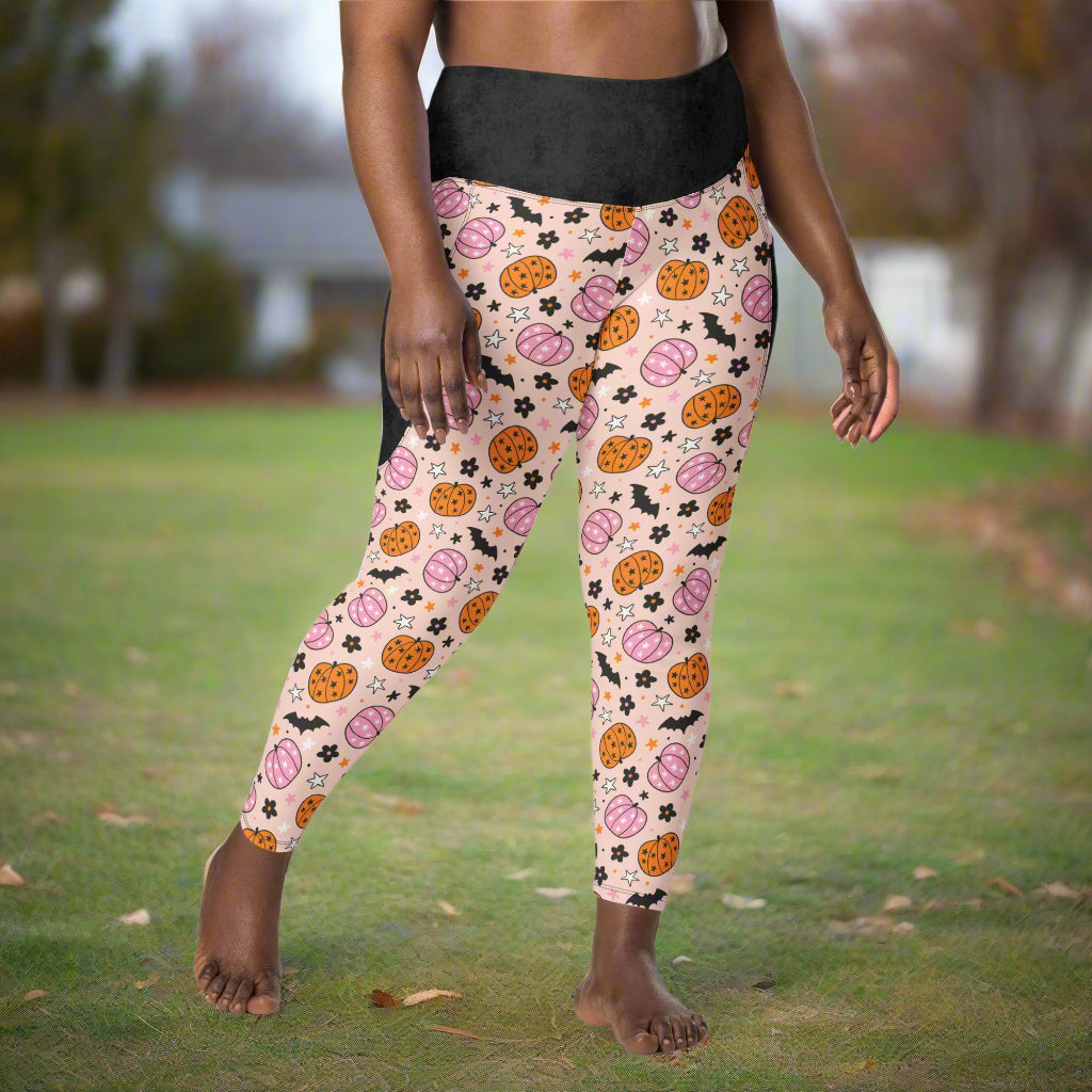 Leggings with Halloween-themed pattern worn by a person against a neutral background
