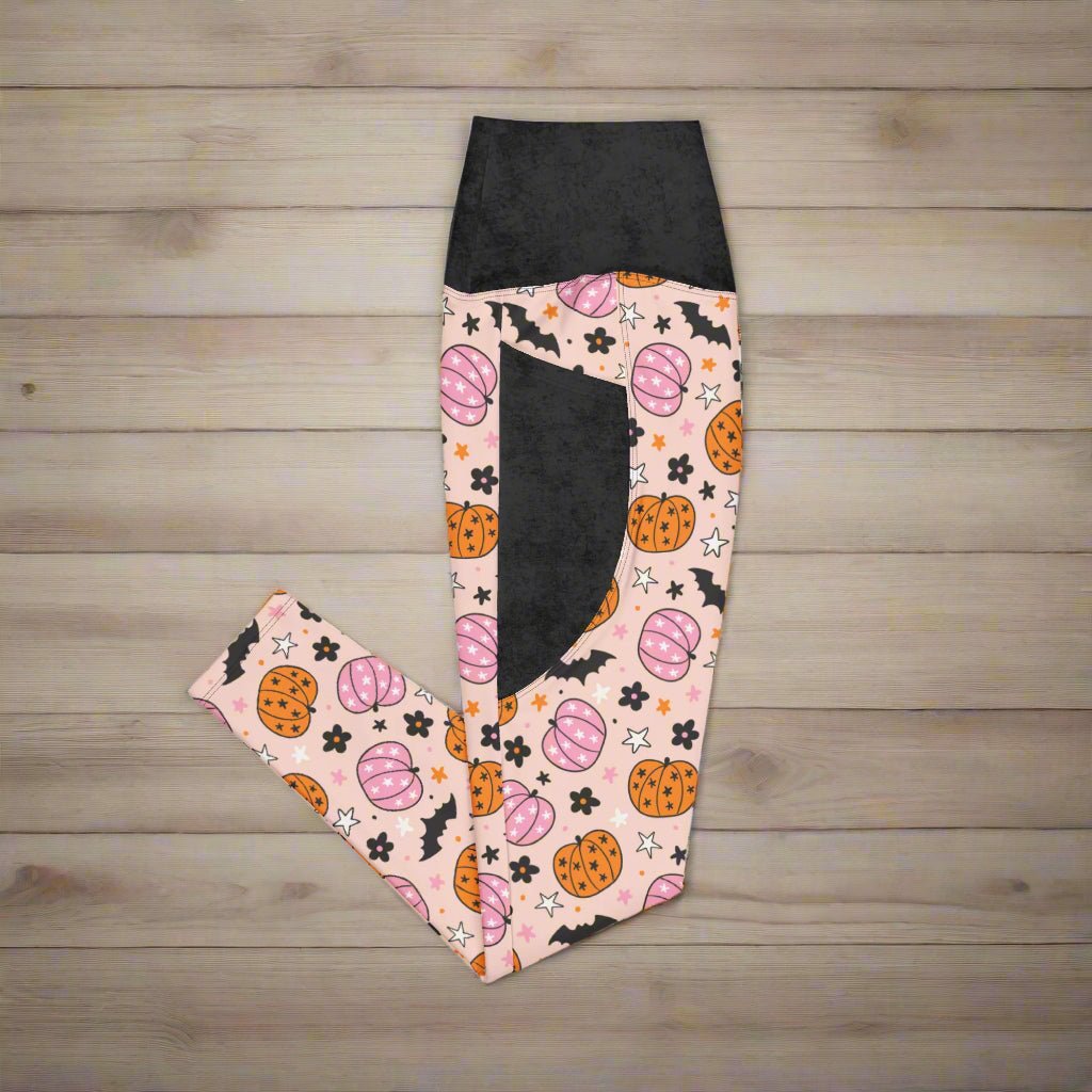 Leggings with Halloween-themed pattern on a wood background