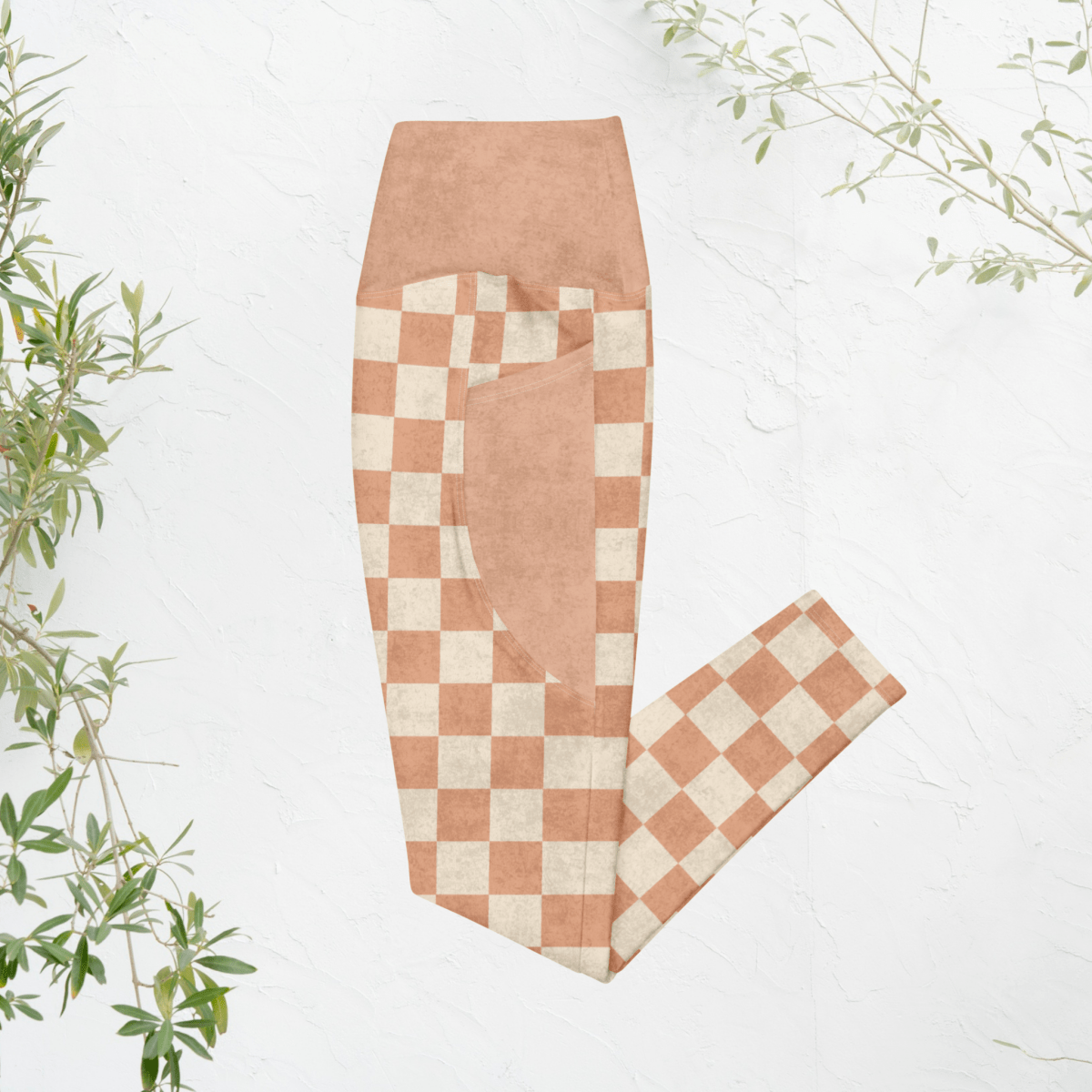 Checkered pants with a pumpkin and cream checkered pattern on a white background