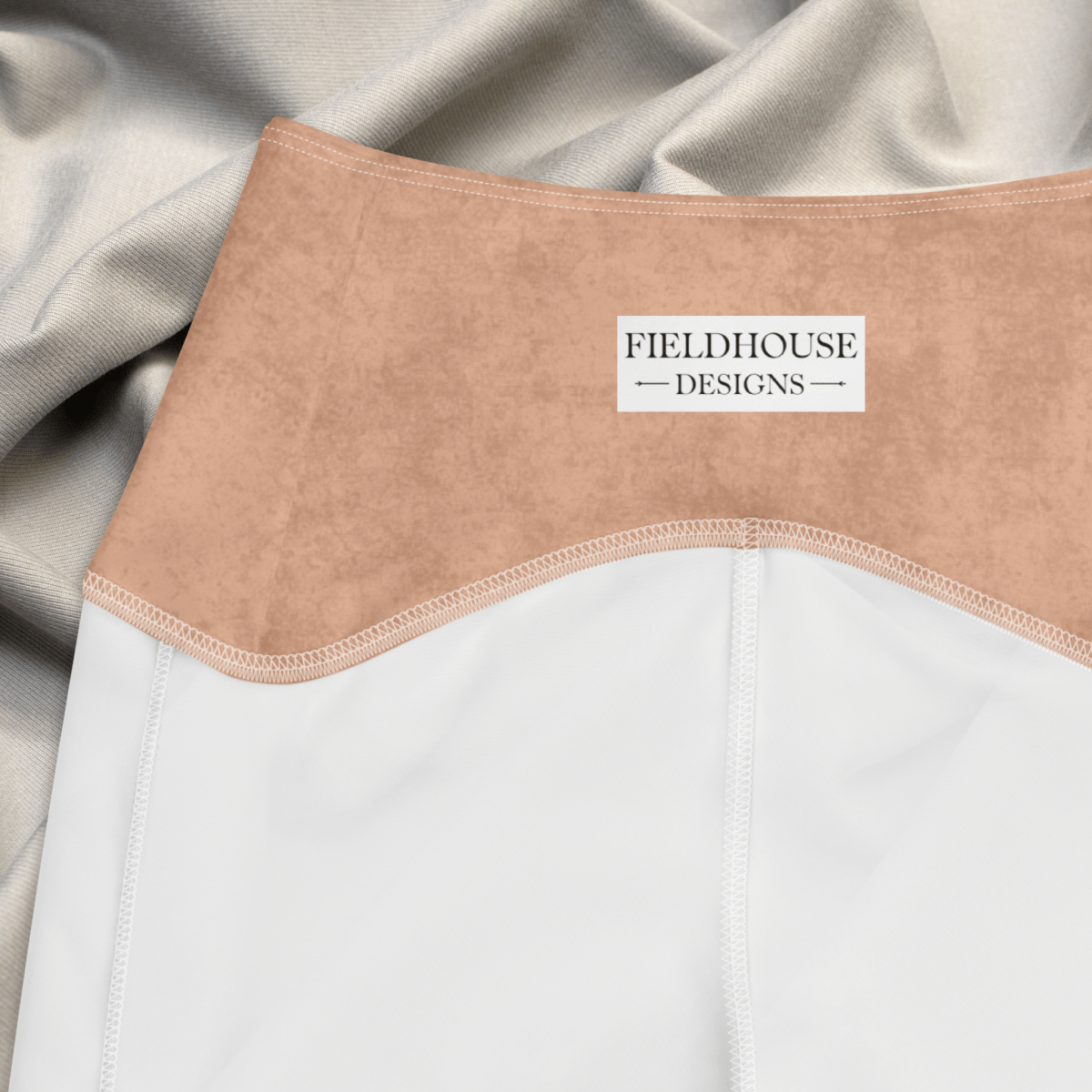 Close-up of a garment with a pumpkin waistband and 'Fieldhouse Designs' label on a neutral background.