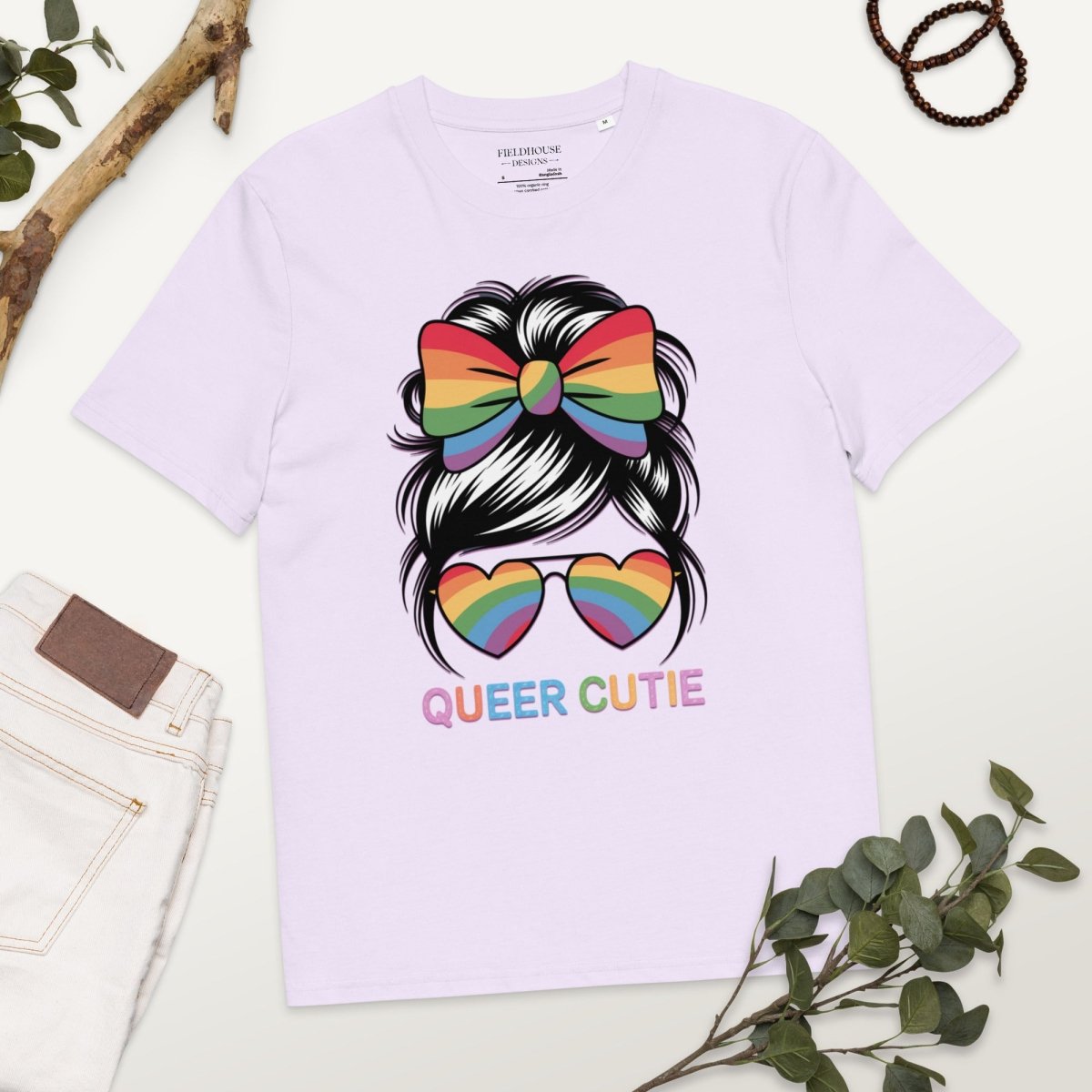 Lavender t-shirt with rainbow hair bow, sunglasses, and 'Queer Cutie' text on a white background.