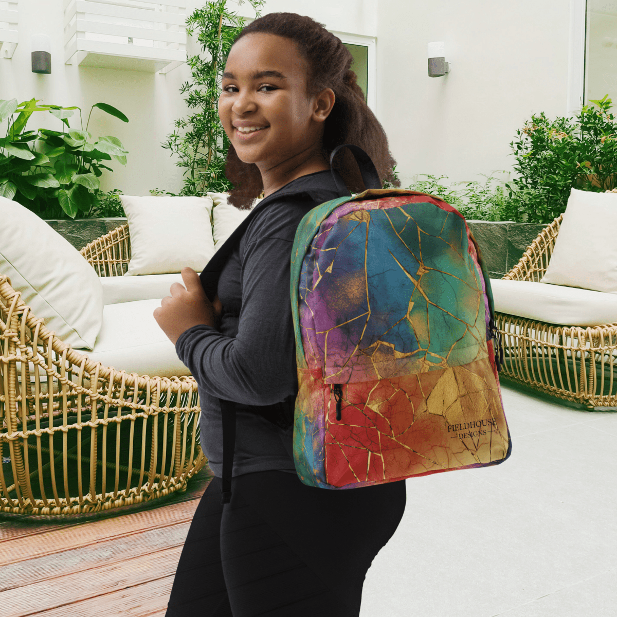 Person wearing a colorful backpack in an outdoor setting