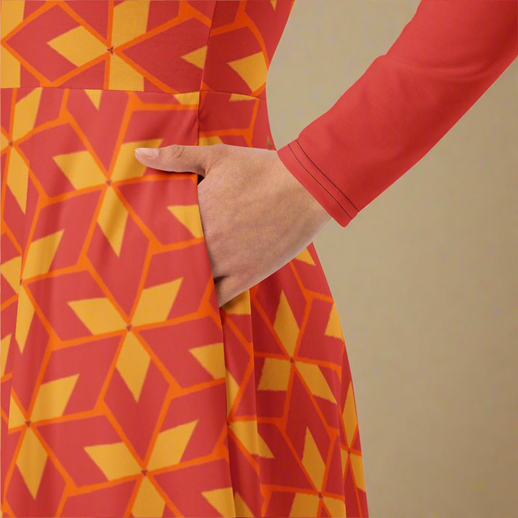 Person wearing a dress with red and yellow geometric pattern against a beige background