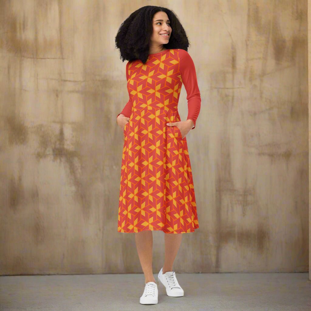 Woman wearing a red dress with yellow pattern on a white background