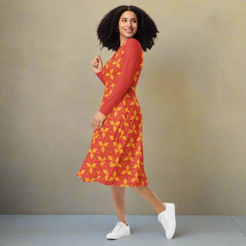 Woman wearing a red and yellow patterned dress against a beige background
