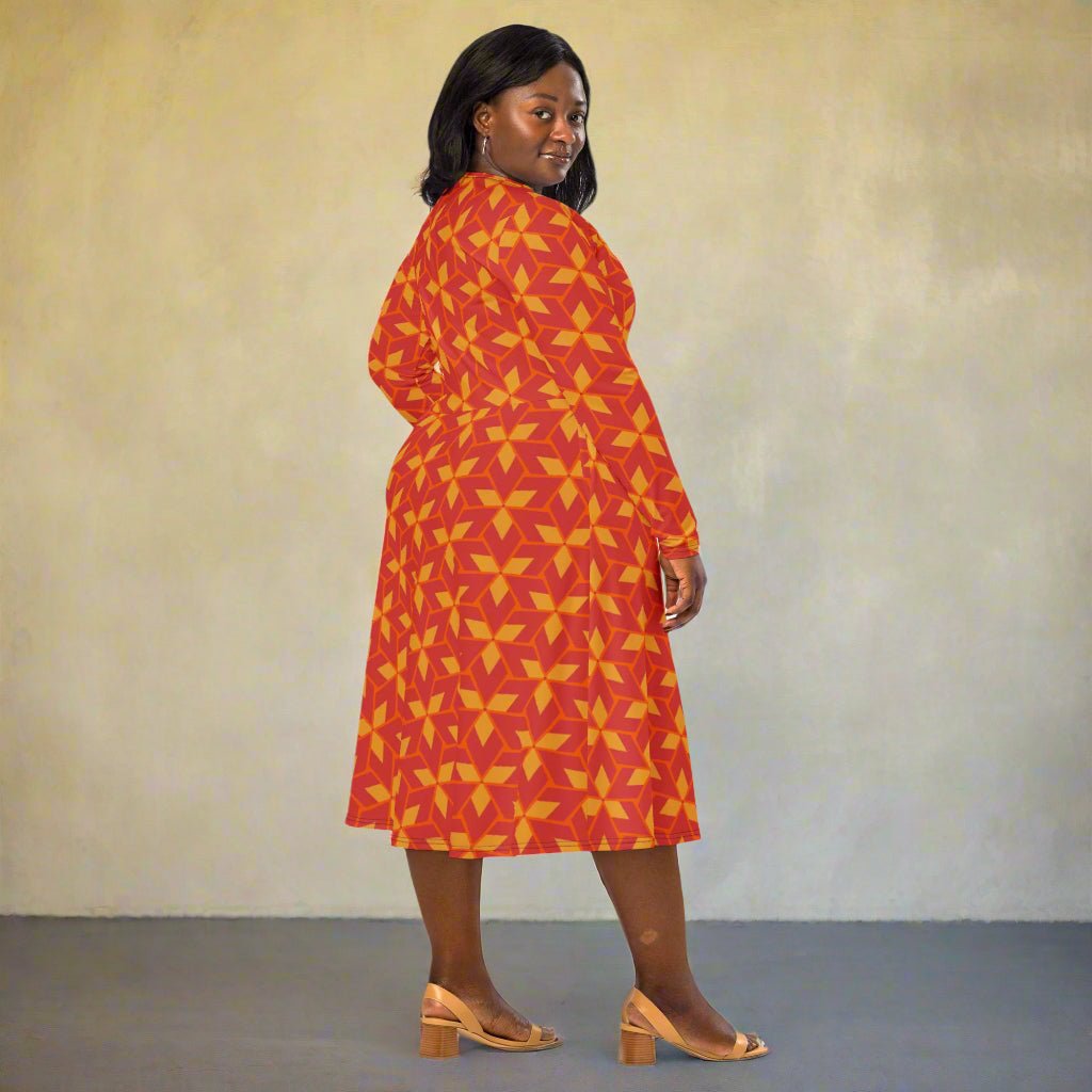 Woman wearing a red and yellow patterned dress on a neutral background
