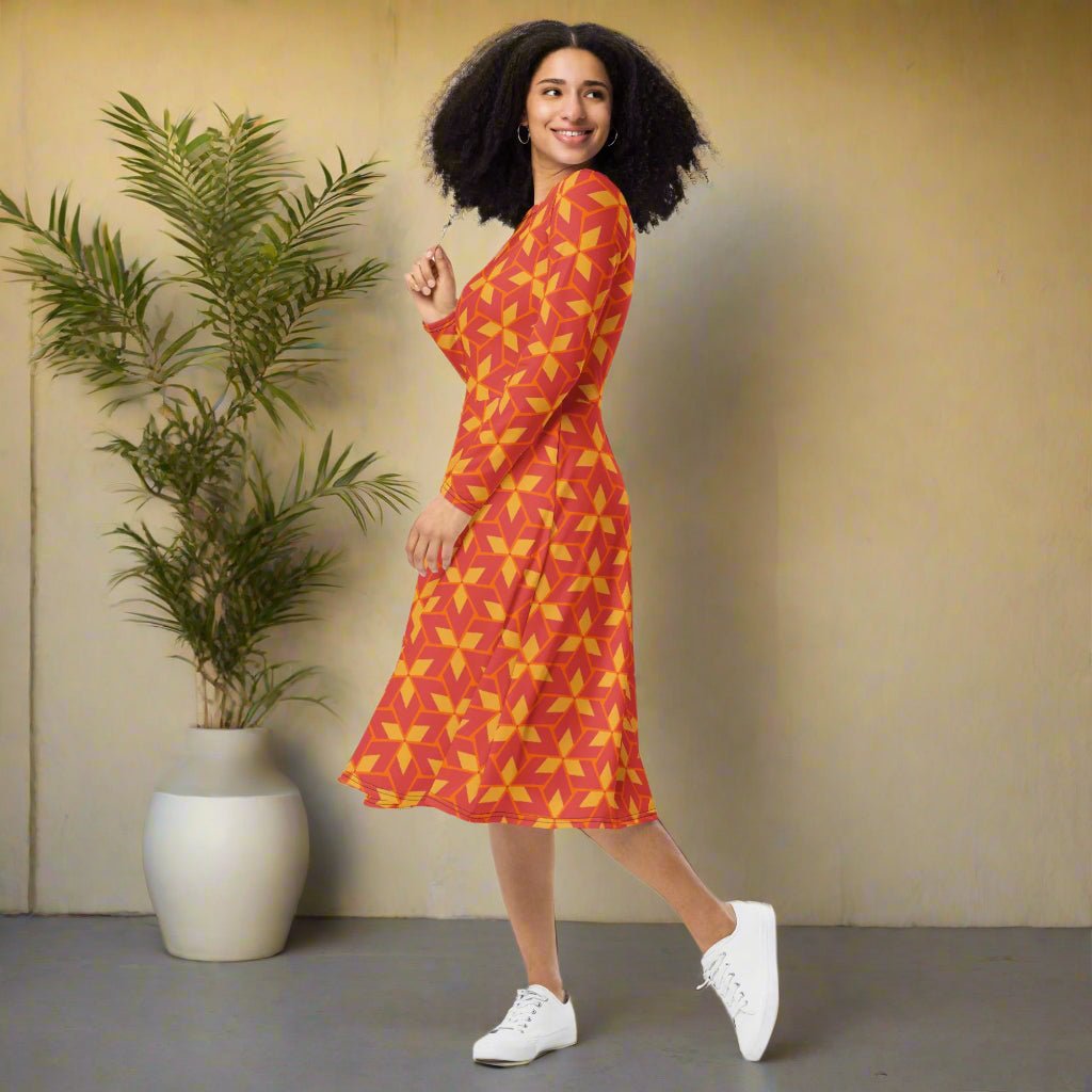 Woman wearing a red and yellow patterned dress on a neutral background