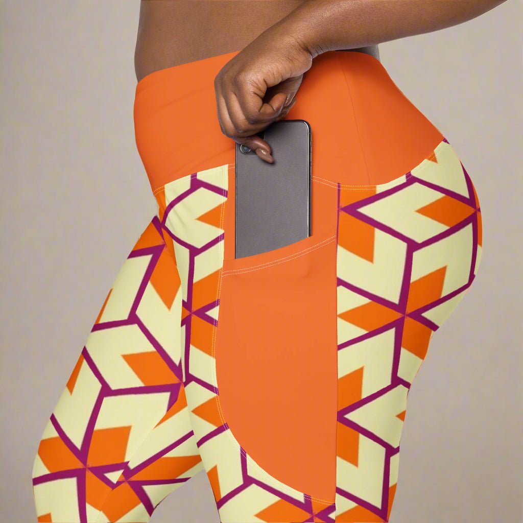 close up of model placin he phone in the pocket of her Orange Retro Geometric High-Waisted UPF 50+ Pocket Leggings 2XS–6XL | Dopamine Dressing Recycled Yoga Pants | Moisture Wicking Compression