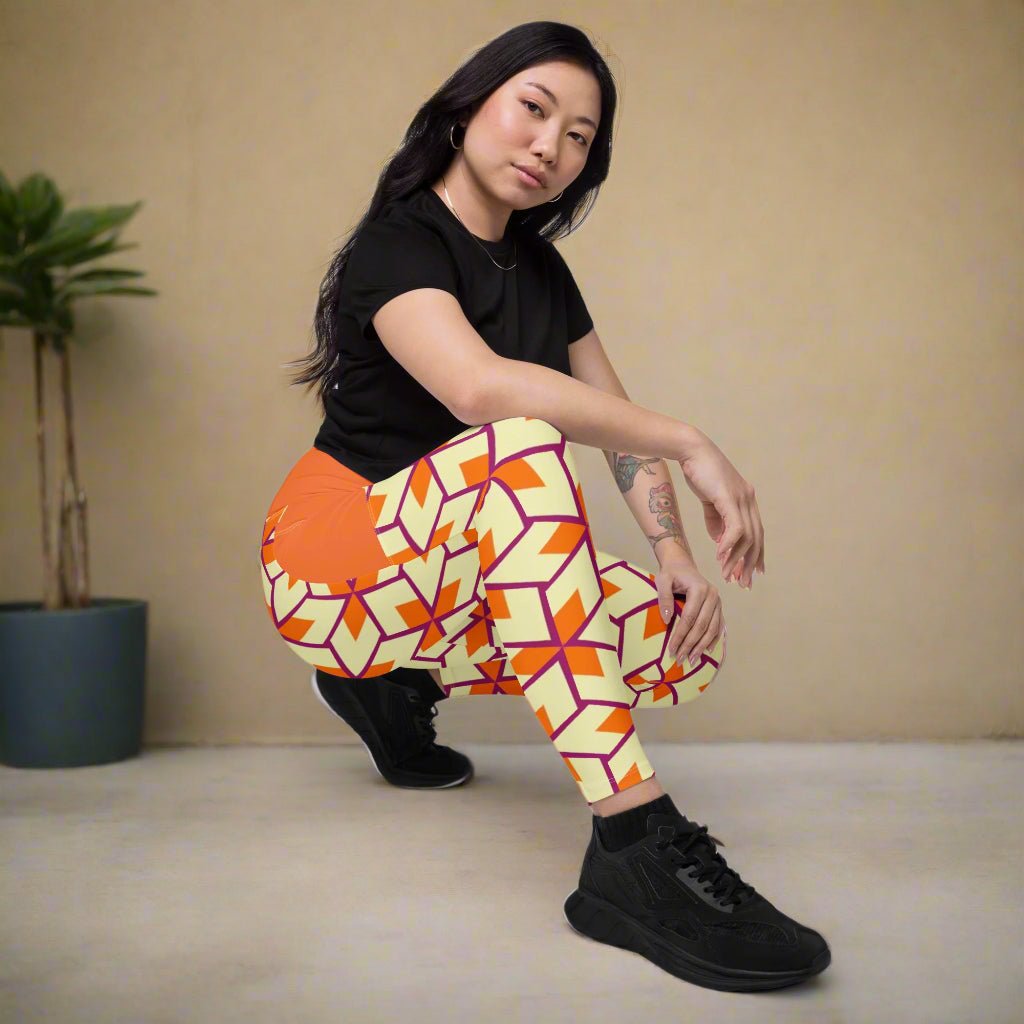 model crouching while wearing Orange Retro Geometric High-Waisted UPF 50+ Pocket Leggings 2XS–6XL | Dopamine Dressing Recycled Yoga Pants | Moisture Wicking Compression