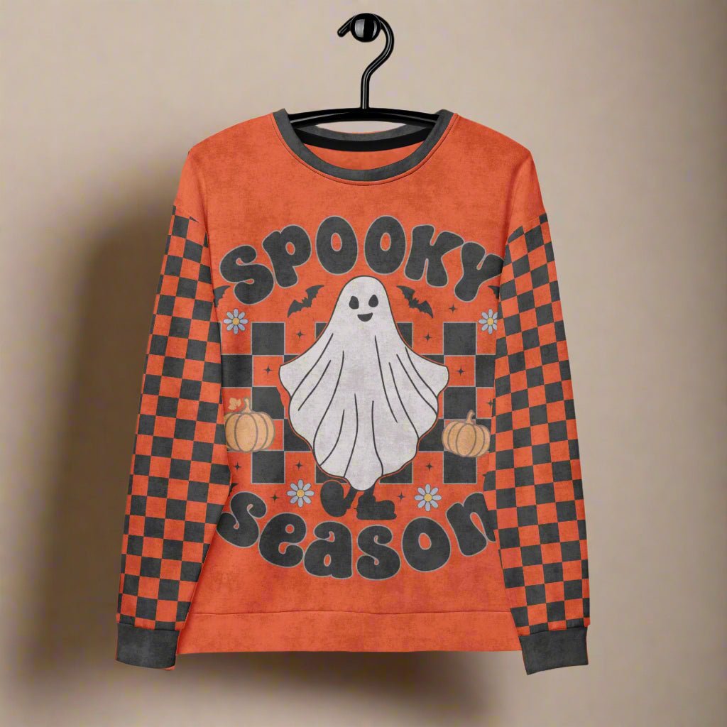 Halloween-themed sweatshirt with ghost and pumpkins design on a hanger