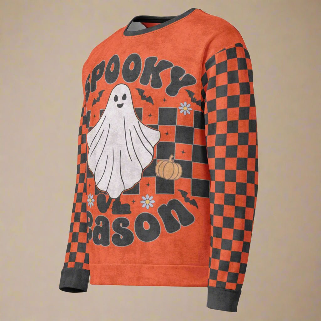 Halloween-themed sweater with ghost, pumpkins, and checkered pattern on an orange background
