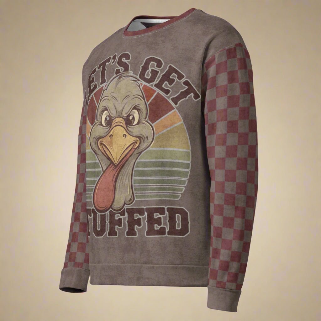 Sweatshirt with a cartoon turkey design and lets get stuffed on a beige background