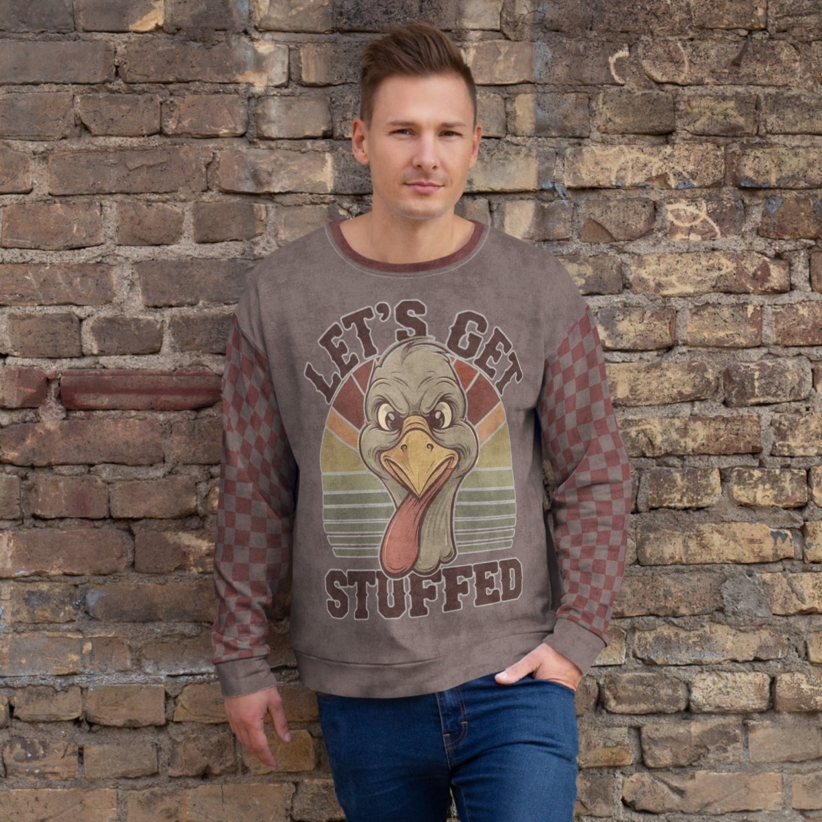 Man wearing a sweater with a turkey graphic and text against a stone wall.