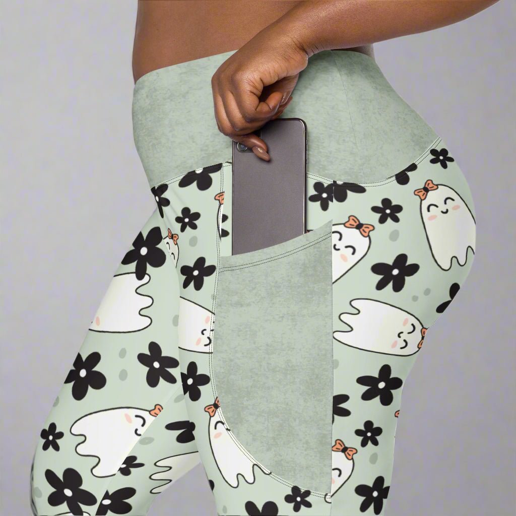 Light green leggings with ghost and flower pattern worn by a person.