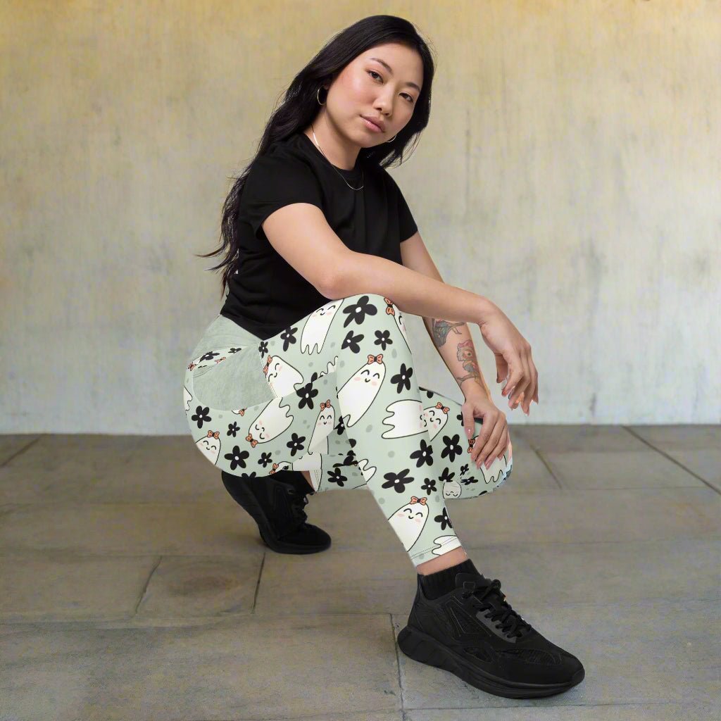 Person wearing a black t-shirt and patterned pants on a beige background