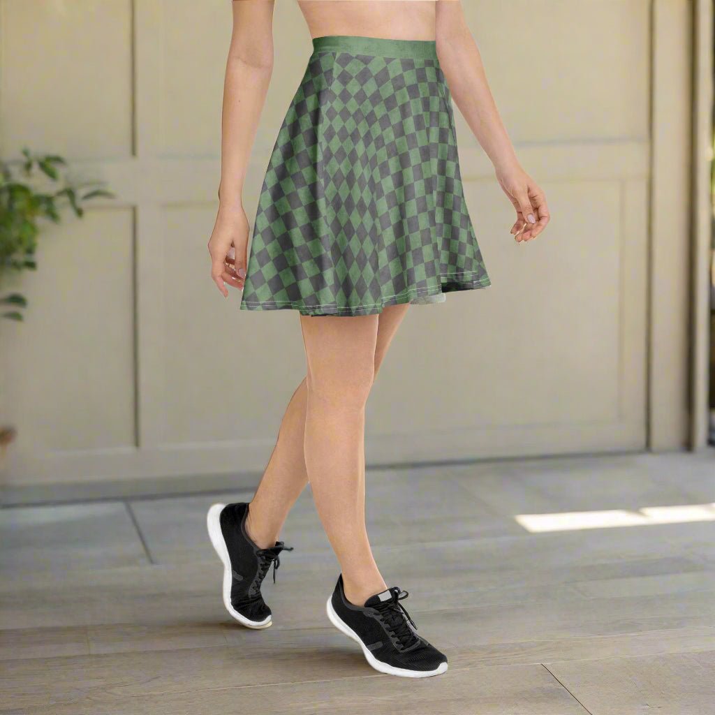Person wearing a green patterned skirt and black sneakers indoors.