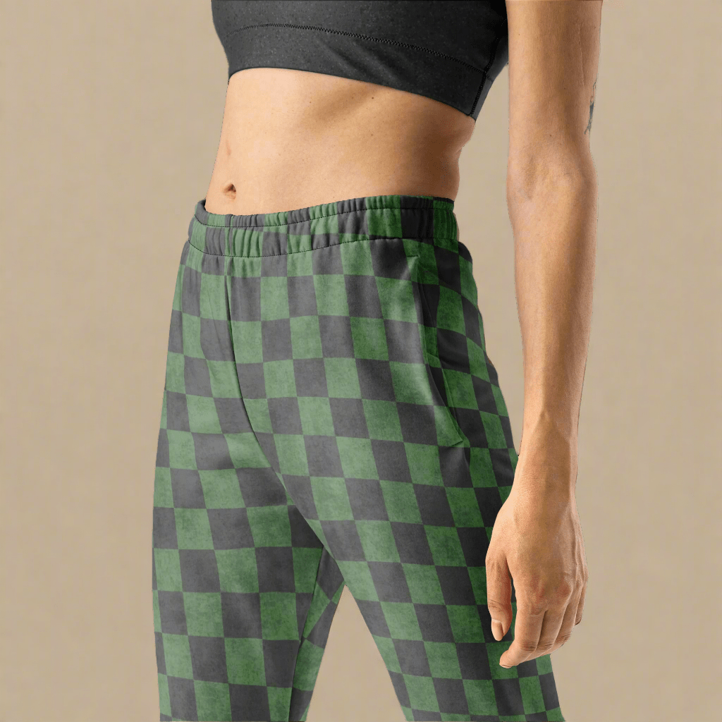 Green and gray checkered pants worn by a person on a beige background