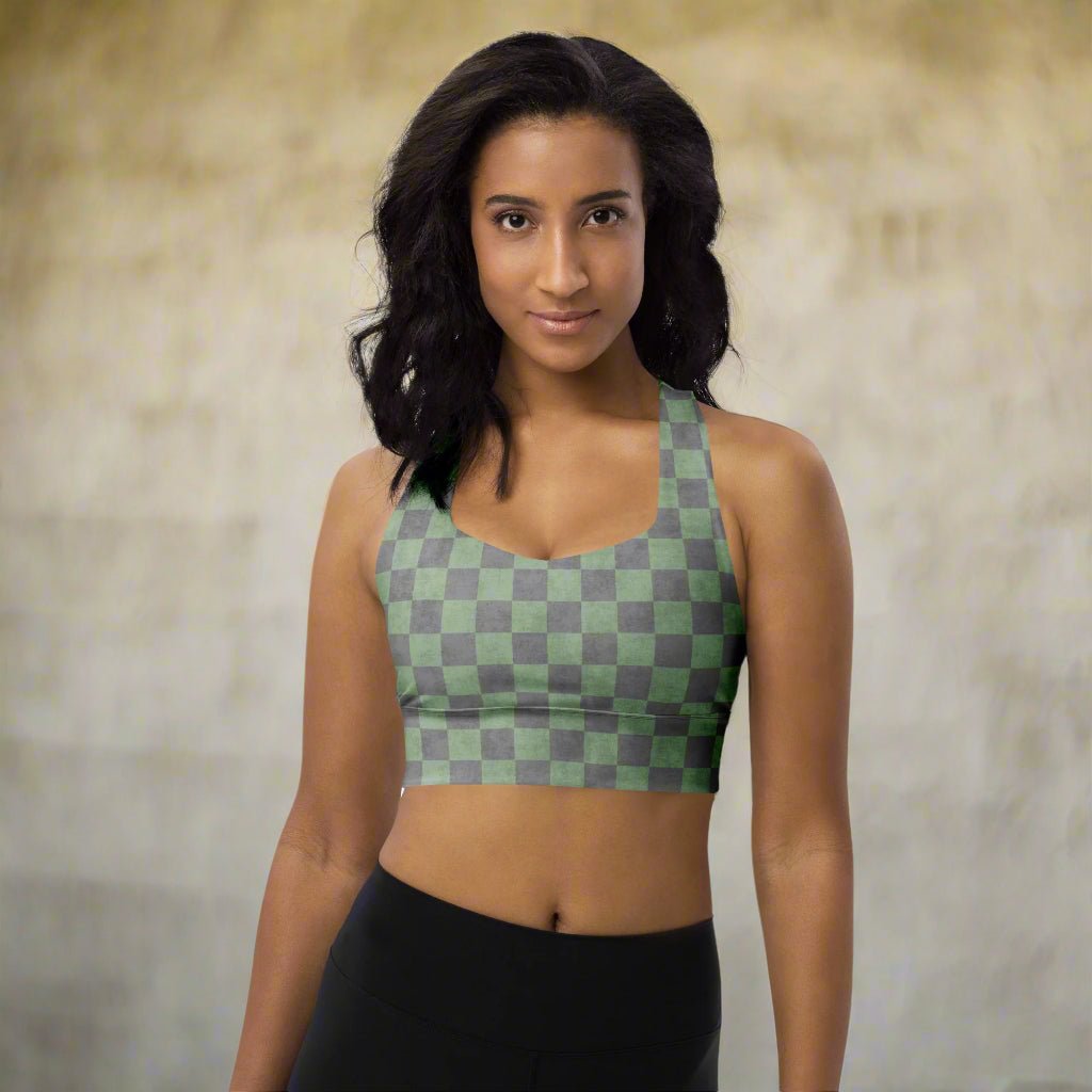 Woman wearing a green and gray checkered sports bra against a neutral background