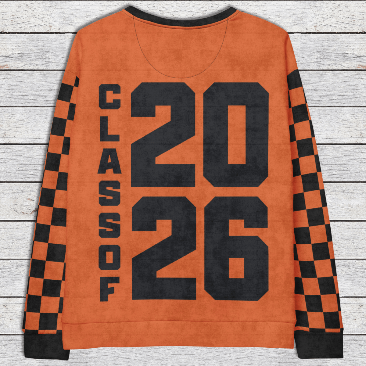 Orange sweatshirt with 'Class of 2026' text on a wooden surface