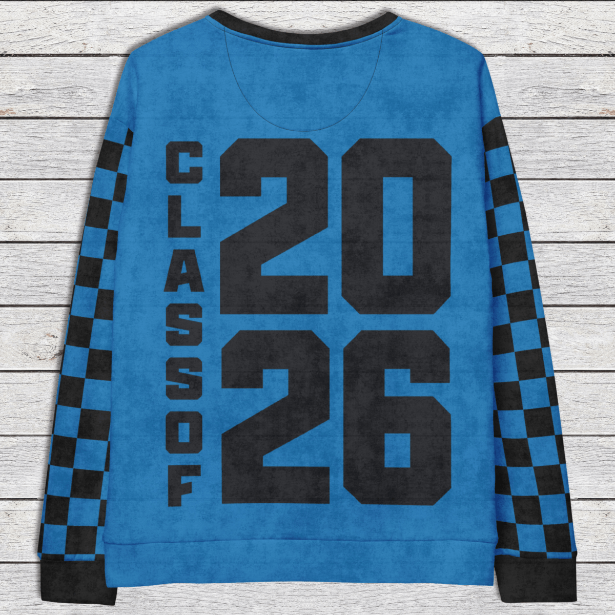 Blue sweatshirt with 'Class of 2026' text on a wooden surface