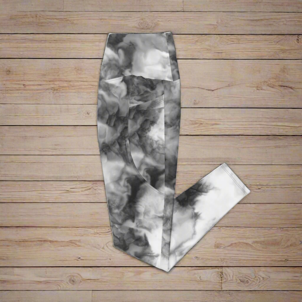 White Tie-Dye High-Waisted UPF 50+ Pocket Leggings 2XS–6XL - Monochrome Recycled Yoga Pants, folded and laying flat on a wood surface