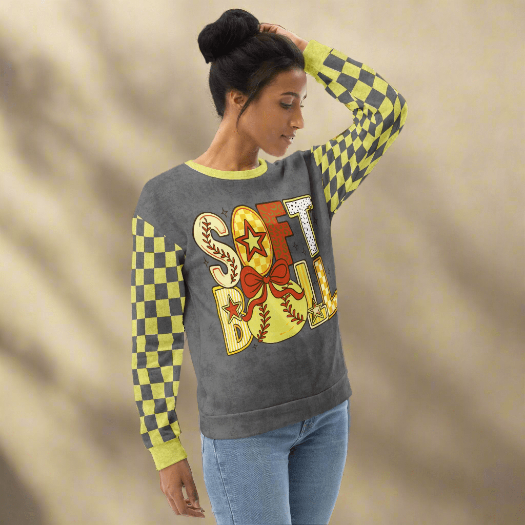 Woman wearing a colorful checkered sleeve sweatshirt with 'SOFTBALL' design on a beige background