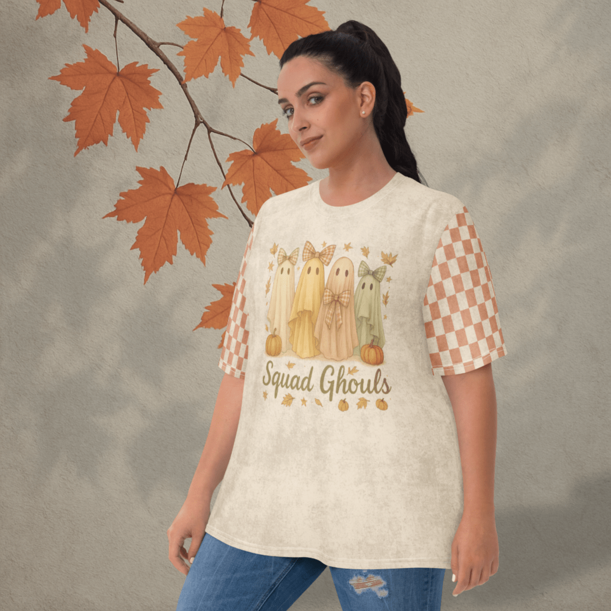 Woman wearing a 'Squad Ghoul' t-shirt with checkered sleeves against an autumn leaf background
