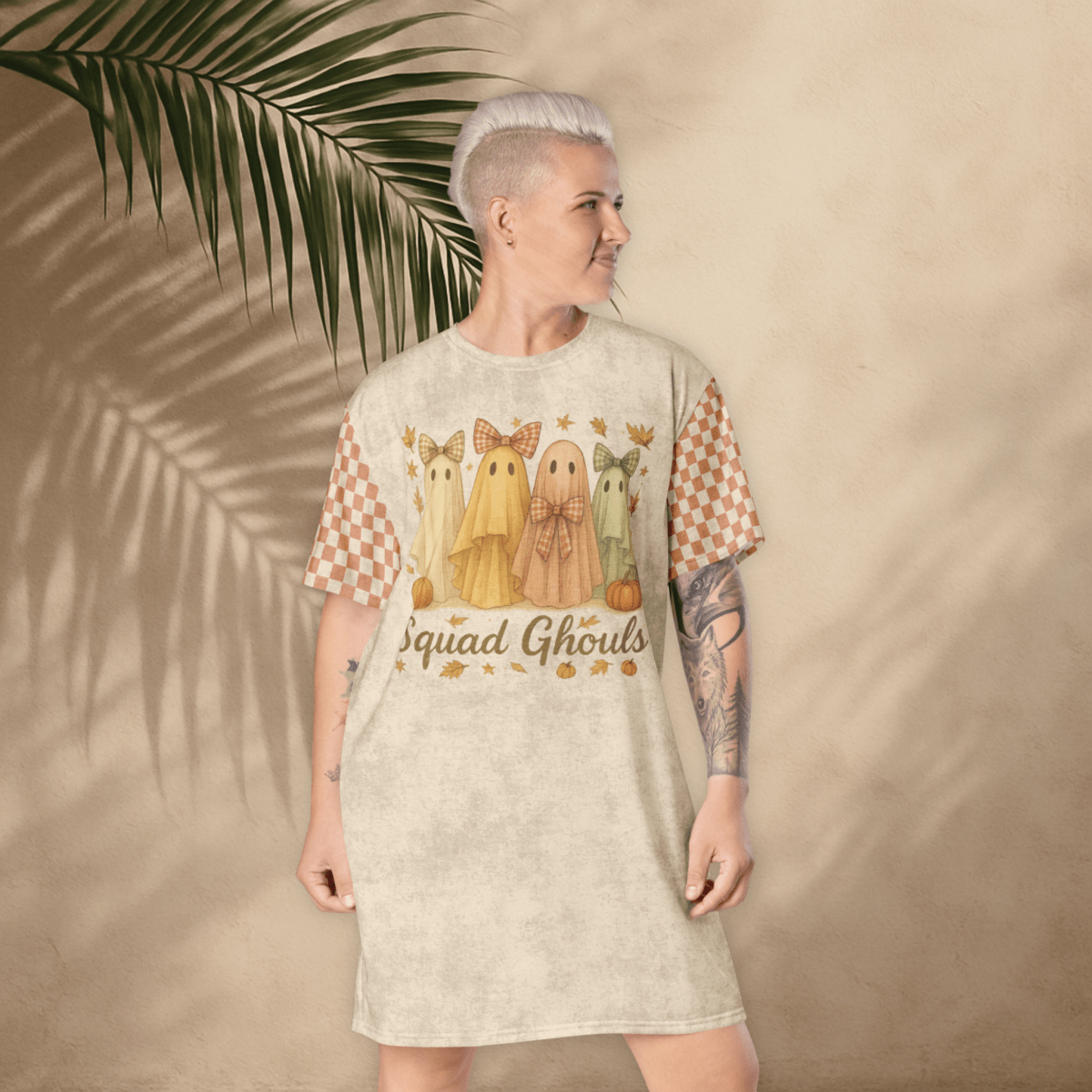 Person wearing a dress with ghost illustrations and 'Squad Ghouls' text against a beige background