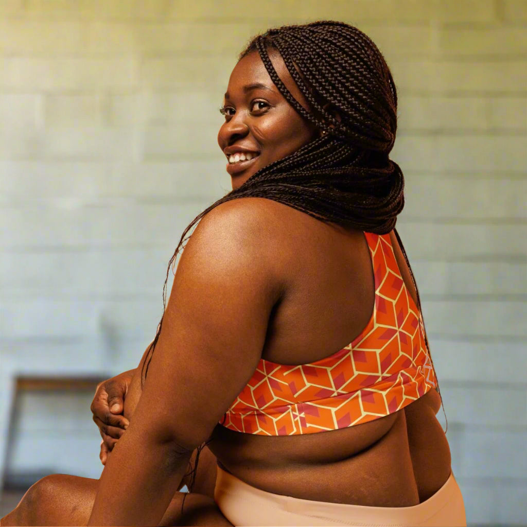 model in orange geometric sports bra