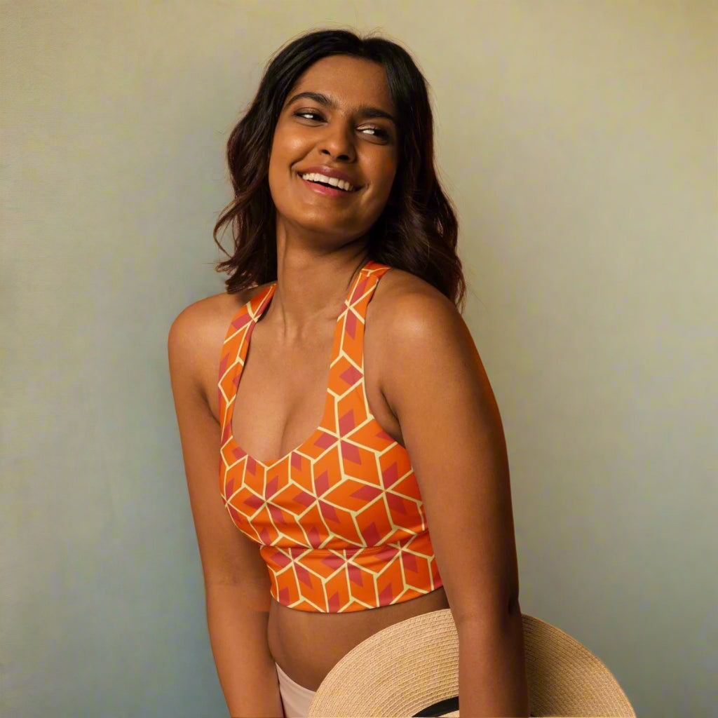 model in orange geometric sports bra