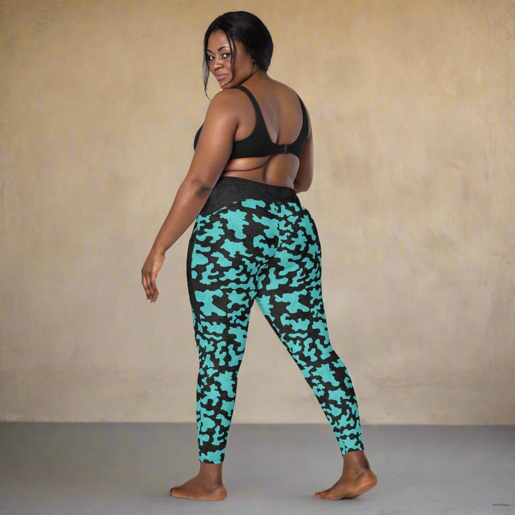 Woman wearing teal camouflage leggings on a neutral background