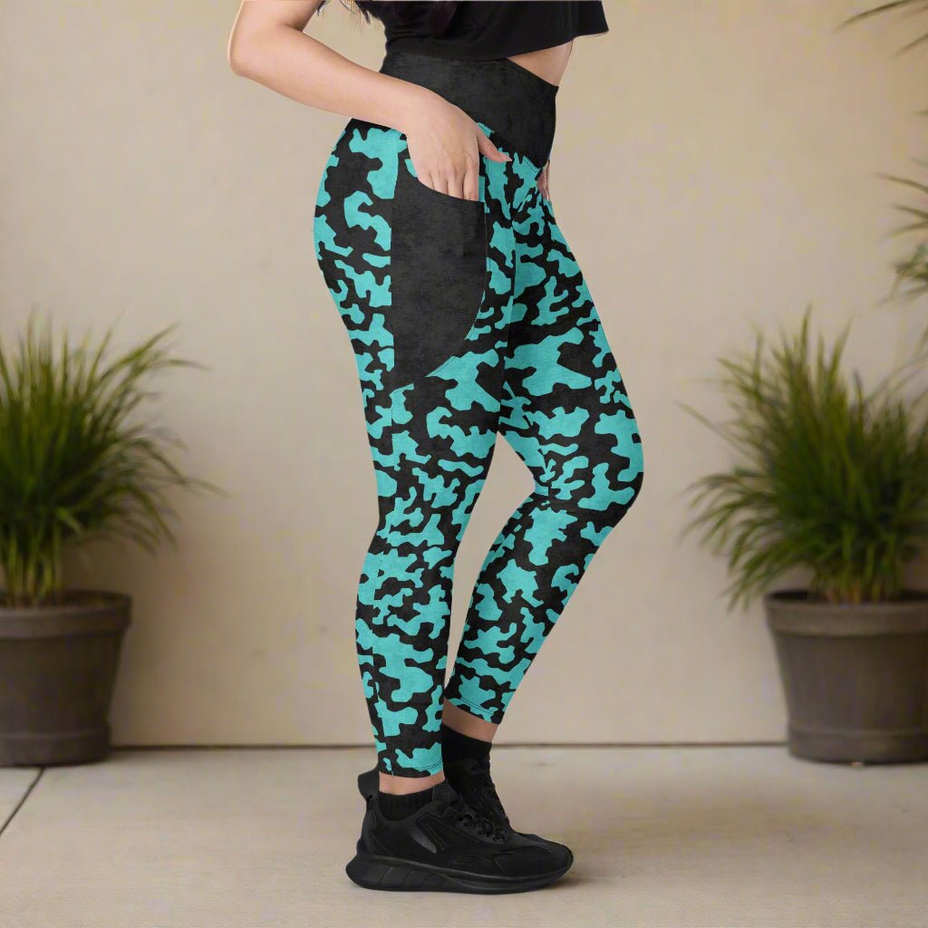 Person wearing teal and black camouflage leggings with a neutral background