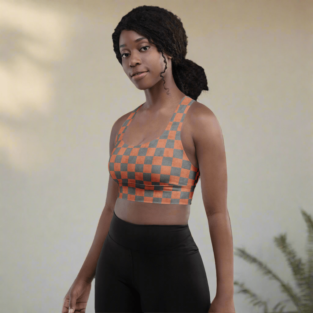 Woman wearing a checkered sports bra and black leggings against a neutral background