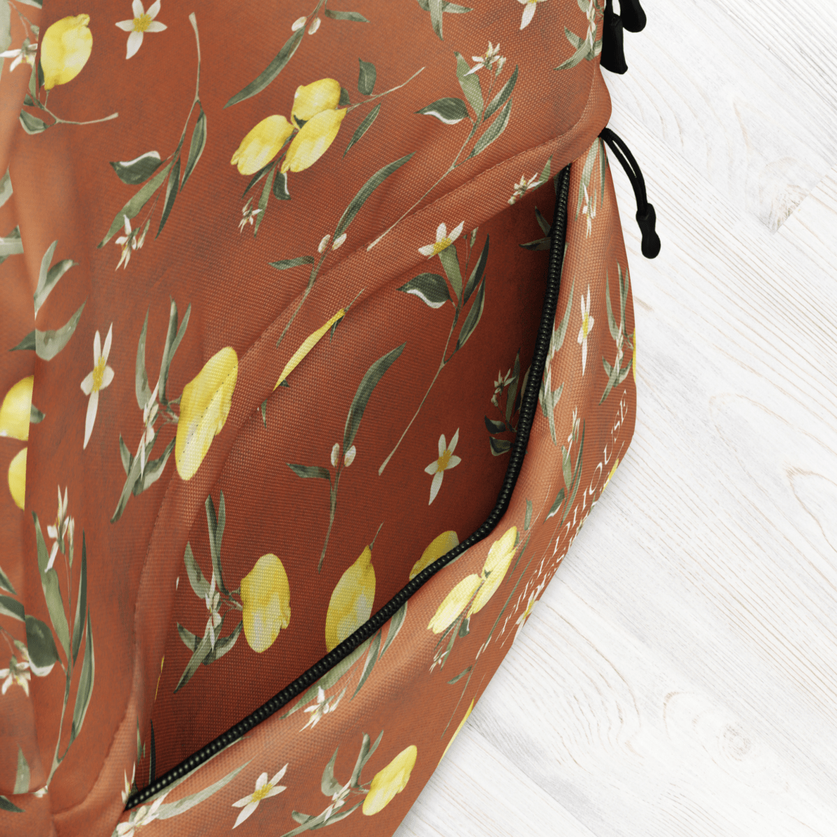 Backpack with lemon and leaf pattern on a white background