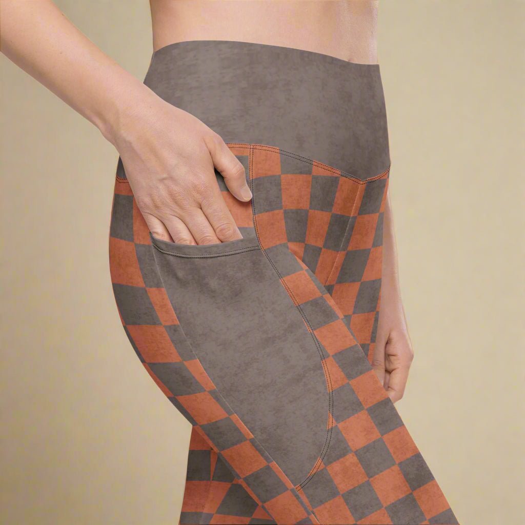 Person wearing leggings with an espresso checkered pattern on a white background