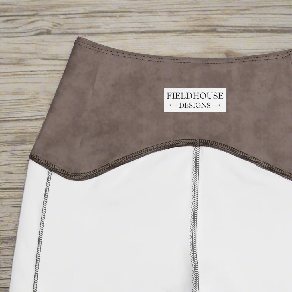 Close-up of a waistband with 'Fieldhouse Designs' label on a wood background