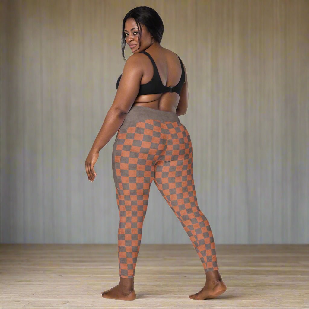 Woman wearing checkered leggings on a neutral background