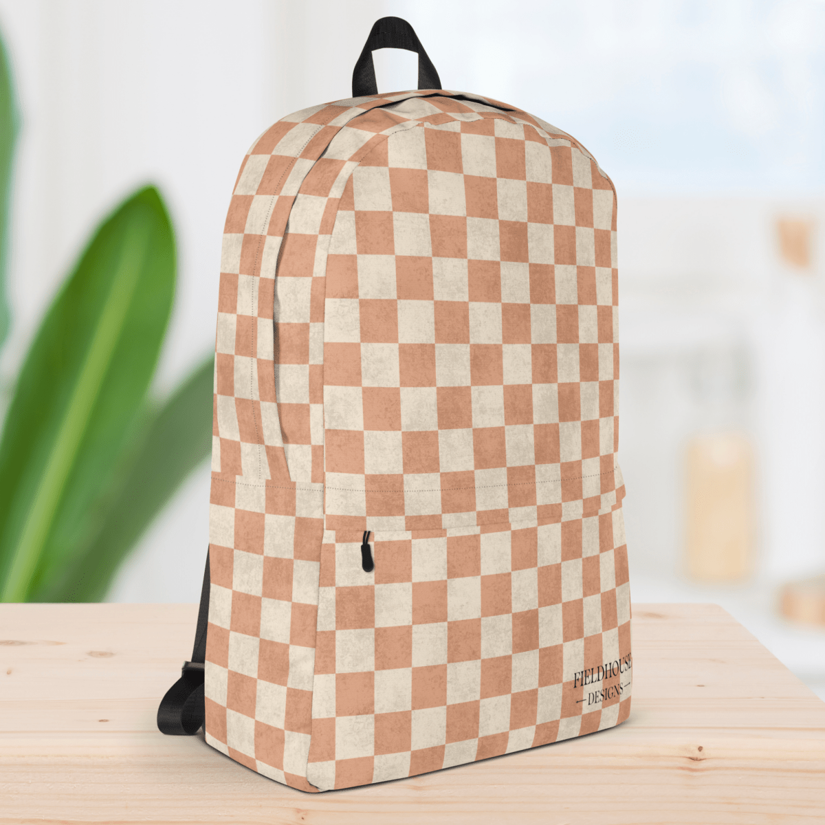 Checkered backpack on a wooden surface with a blurred background