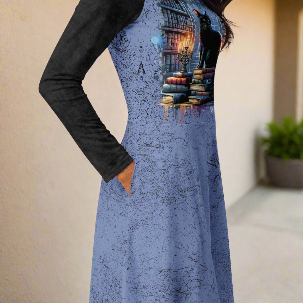 Blue dress with a graphic design of books and a black cat