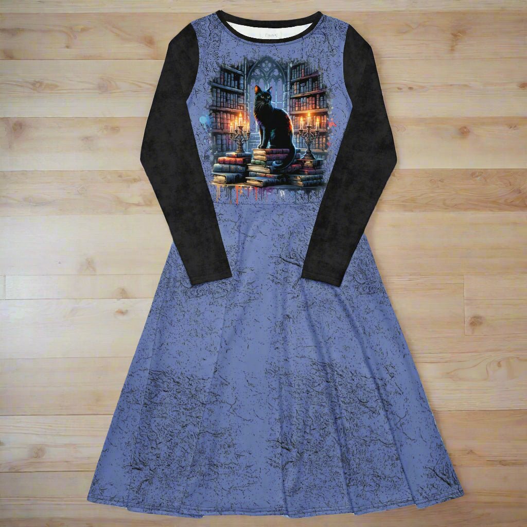 Blue dress with black long sleeves featuring a cat and book design on a wooden surface