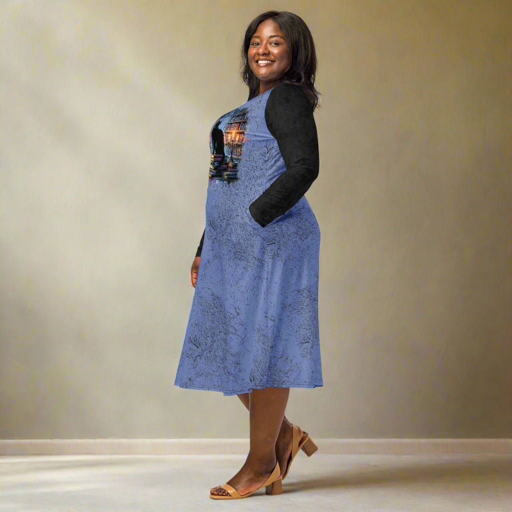 Woman wearing a blue dress with black sleeves against a beige background