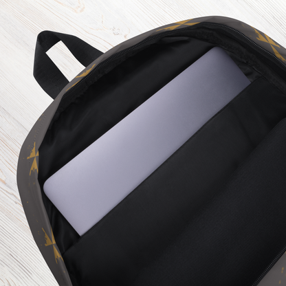 gray backpack with a laptop inside on a light wooden surface