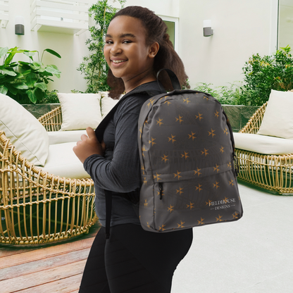 Person wearing a gray backpack with star patterns in an outdoor setting
