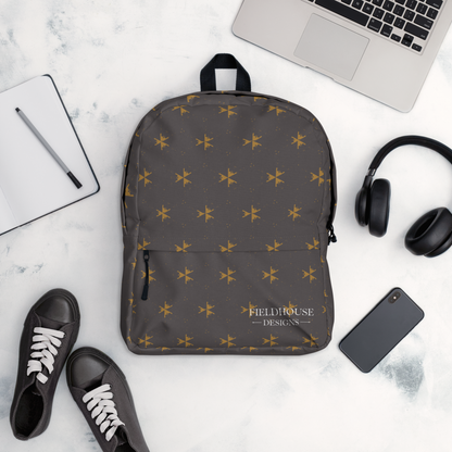 Gray backpack with star pattern on a white surface with laptop, phone, shoes, and headphones.