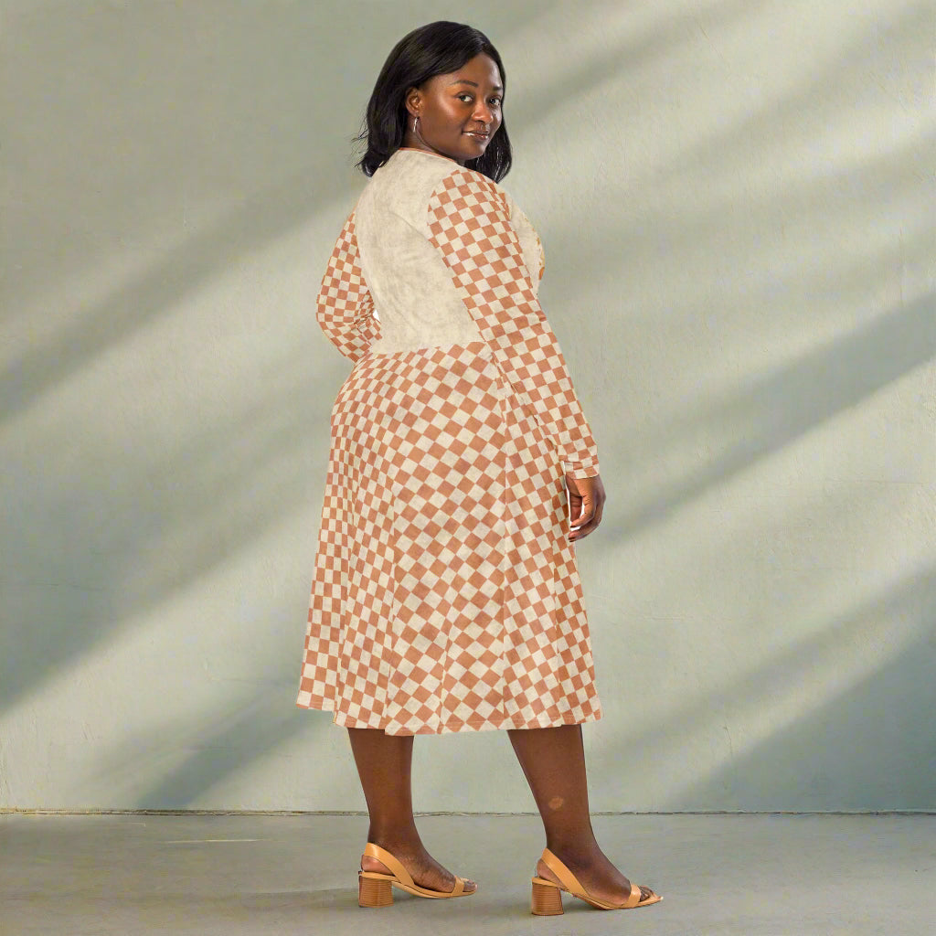 Woman wearing a patterned dress on a plain background