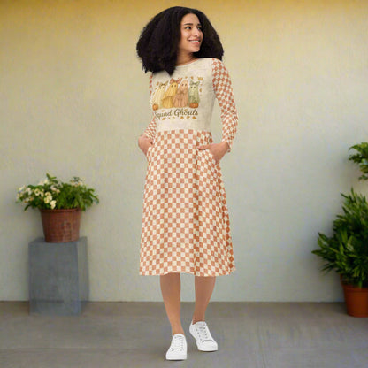 Woman wearing a dress with a checkered pattern and graphic design on a white background