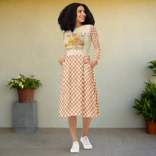 Woman wearing a dress with a checkered pattern and graphic design on a white background