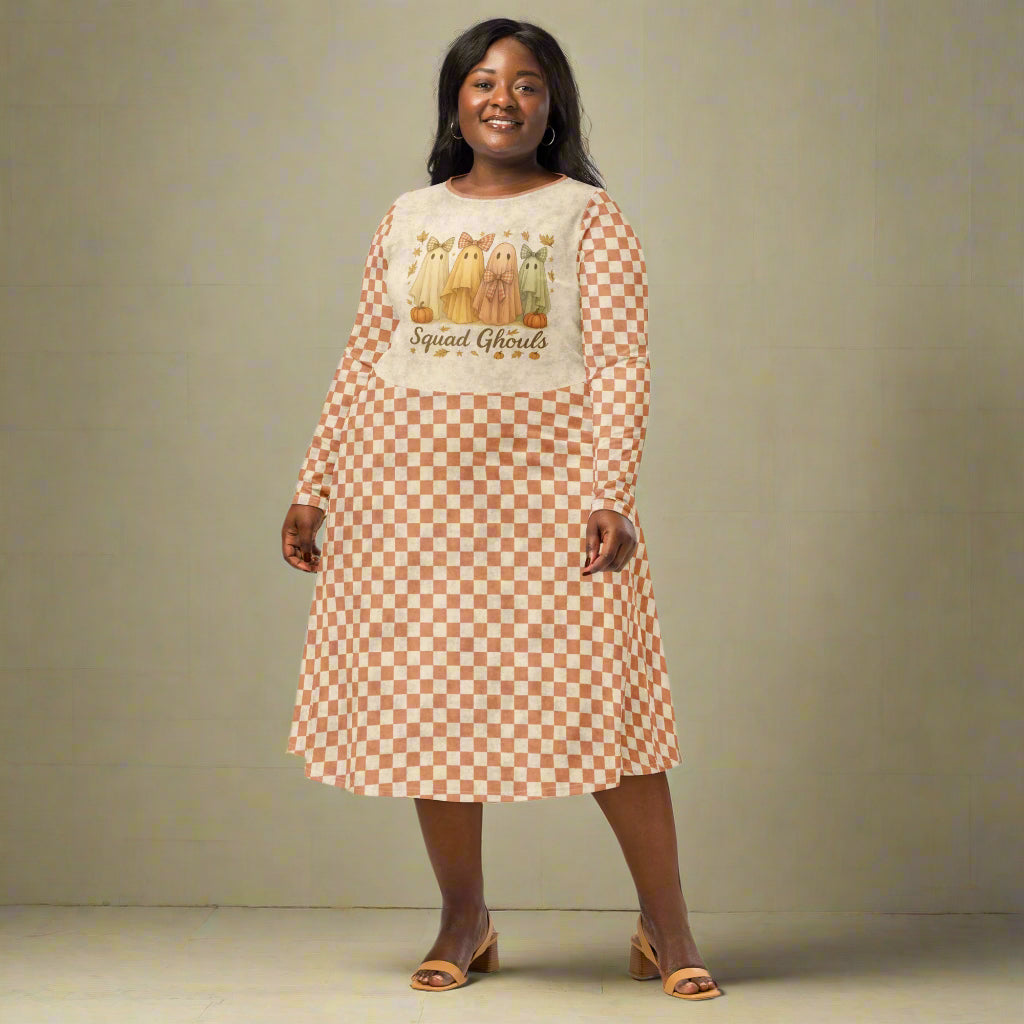 Woman wearing a checkered dress with a graphic design on a plain background