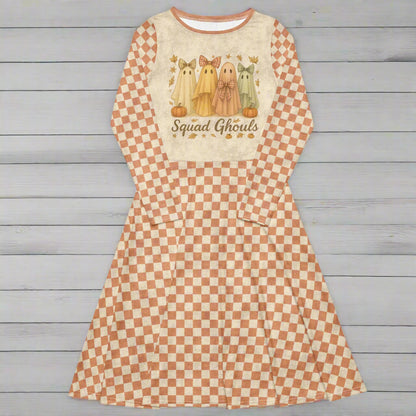 Checkered dress with ghost design and 'Squad Ghouls' text on a wood background