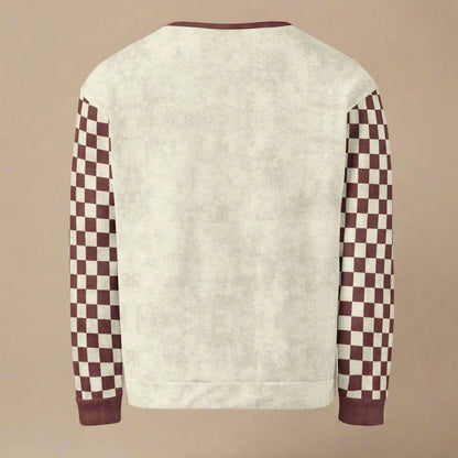 Sweater with checkered sleeves on a beige background